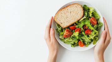 Healthy Lunch Break with Fresh Salad and Whole Grain Bread on White Background photo