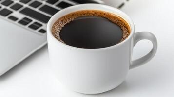 Hot Coffee Mug on Desk Next to Laptop During Office Lunch Break for Productivity and Relaxation photo