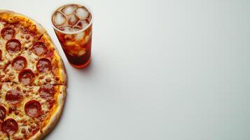Pepperoni Pizza and Iced Drink on White Background - Perfect Lunch Break Meal photo