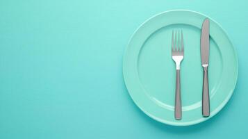 Elegant Dinner Concept with Fork, Knife, and Plate on a Turquoise Background for Modern Dining Themes photo