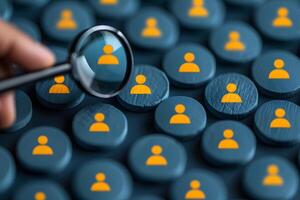 Magnifying Glass Analyzing Yellow User Icons on Blue Wooden Buttons for Recruitment Concept photo