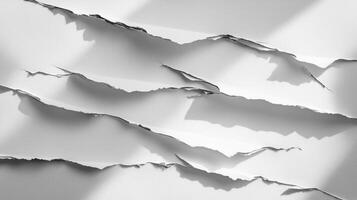 Scattered layers of torn paper with uneven edges create a textured backdrop casting soft shadows that enhance the artistic appeal for presentations and designs. photo
