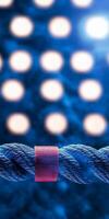 Illuminated ropes stretch across a stylized ring casting a dramatic background of soft glowing lights enhancing the thrilling atmosphere of the performance. photo