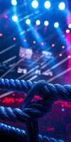 vibrant lights highlight a wrestling ring equipped with three ropes setting the stage for an electrifying performance where athletes showcase their skills. photo