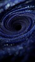 Purple particles unite to create a stunning vortex that glows intensely at the center, swirling with cosmic energy against a stark black background, showcasing captivating motion. photo