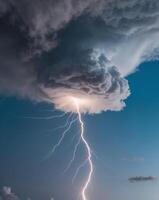 A lightning bolt is seen in the sky above a cloud photo
