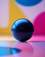 A blue ball sitting on a table in front of a colorful background photo