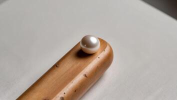 A tight shot of a wooden end with a pearl embedded in its center. photo