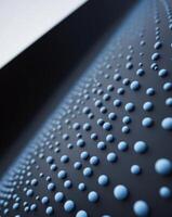 A close up of a black surface with blue bubbles photo
