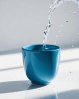 A blue cup with water pouring into it photo