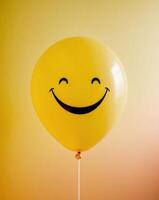 Smiling Yellow Balloon on Yellow Background. photo