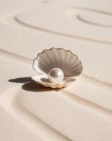 Pearl Inside Shell on Sandy Beach Background. photo