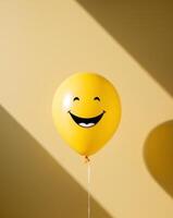 Smiling Yellow Balloon on Yellow Background. photo