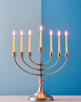 Menorah with Lit Candles on Blue Background. photo