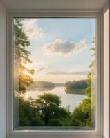 A window looking out onto a lake and trees photo