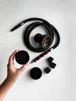 Hookah components set, bowl, hose, charcoal cubes, and fresh tobacco photo