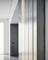 A hallway with a white door and a black door photo