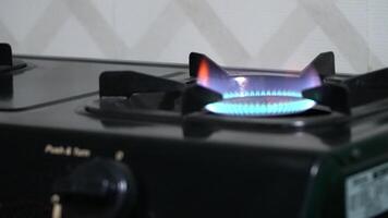 Close up view of a stove being turned on, with the burner igniting and emitting a soft glow video