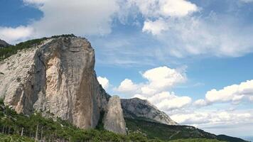 A Majestic Mountain Towering Over a Vertical Cliff Face video