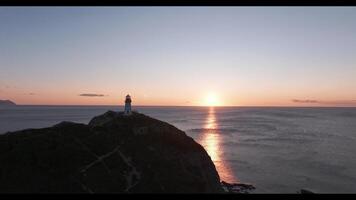 The Guiding Beacon. A Majestic Lighthouse Perched on a Rugged Cliff Overlooking the Vast Ocean video