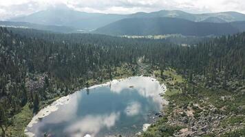 A Serene Reflection. Majestic Lake Encircled by Towering Trees and Majestic Mountains video