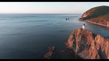 The Serene Beauty of a Person Standing Majestically on a Cliff Overlooking the Vast Ocean video