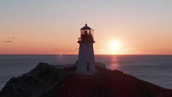 The Guiding Beacon. A Majestic Lighthouse Perched on a Cliff Overlooking the Vast Ocean video