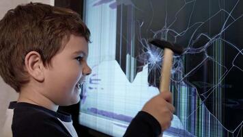 The Curious Handyman. A Young Boy Fixing a Broken Screen with a Hammer video