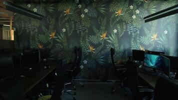 Empty office room after working day with lights off. Stock footage. Modern office with computers and decorative wall. video
