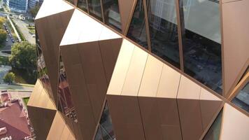 Close up of the skyscraper facade with pyramid like shapes and glass windows. Stock footage. Concept of architecture. video