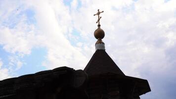 Ancient wooden architecture of church. Media. Wooden buildings of ancient church on background sky. Ancient wooden church with cross video