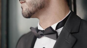 Close-up of man in elegant suit with bow tie. Action. Man in suit for event. Man with elegant suit and bow tie video