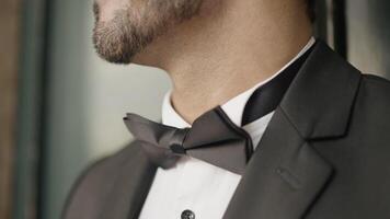 Close-up of man in elegant suit with bow tie. Action. Man in suit for event. Man with elegant suit and bow tie video