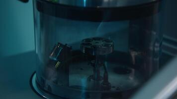Devices in the laboratory for research. Stock footage. A dark room with new equipment in a special flask that rotate in a circle. video