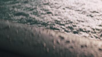 Big cold raindrops on a bridge with a pond below. Action. Cold weather and a flowing river at the bottom with small waves from the wind. video