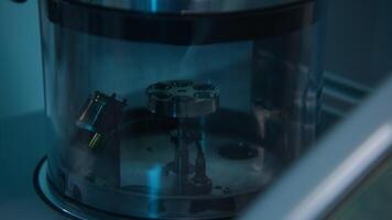 Devices in the laboratory for research. Stock footage. A dark room with new equipment in a special flask that rotate in a circle. video