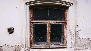 An old dark window. Stock footage. A white old house in which a dark window without light inside is removed in daylight. video