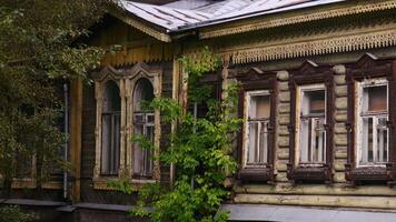 Wooden house. Stock footage. Residential wooden house with old windows overgrown with grass. video