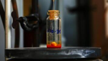 Laboratory test tube with rotating particle and liquid. Stock footage. Rotating liquid in test tube in chemical laboratory. Chemical compound in small test tube video