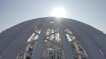 Modern domed structure with white beams. Stock footage. Domed building on sunny day. Modern architecture of domed white building video