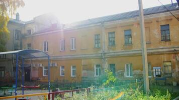 Yellow small apartment building. Stock footage. A small apartment house with a playground inside and windows. video