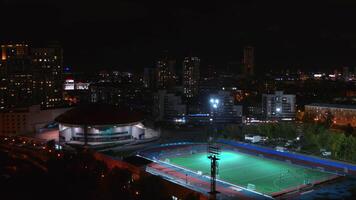 A beautiful city at night. Stock footage. A night city shot from a bird's-eye view with lanterns, tall houses and a stadium. video