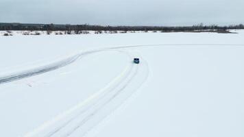 Aerial view of a race car moving fast through the snow desert. Clip. Concept of active lifestyle and sport. video