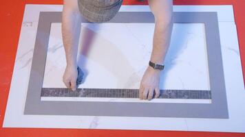 Worker connects tile pattern. Creative. Man connects details of square boards. Man joins pattern of boards and tiles video