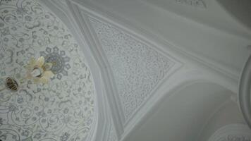 Low angle view of the white ceiling with beautiful ornament. Scene. Carved decorations and floral pattern. video