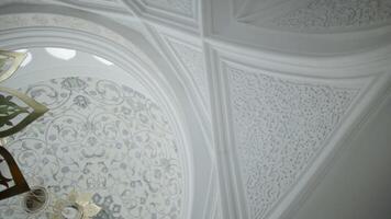 Low angle view of the white ceiling with beautiful ornament. Scene. Carved decorations and floral pattern. video