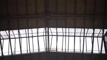 Bottom view of warehouse ceiling. Clip. Ceiling of industrial room with windows. Windows on ceiling with metal body of warehouse video