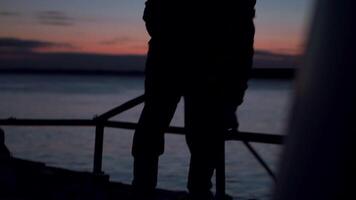 Man cleans deck of fishing boat. Clip. Shadow of man sweeping on ship at dusk. Man cleans up on boat on winter evening at sea video