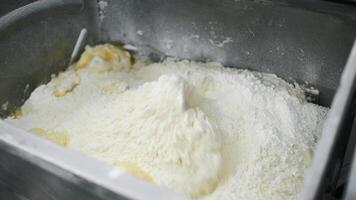 Preparation of dough in industrial machine. Clip. Close up of automatic mixing ingredients for dough with a professional dough mixer. video