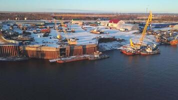 Aerial view of the container terminal in the seaport with cargo ships, operation of cranes and equipment. Clip. The port by the sea. video